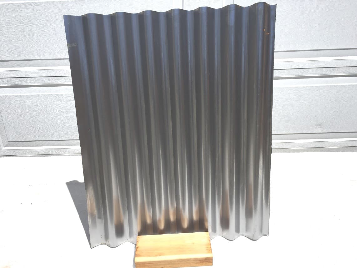 a corrugated metal fence panel after degreasing and etching
