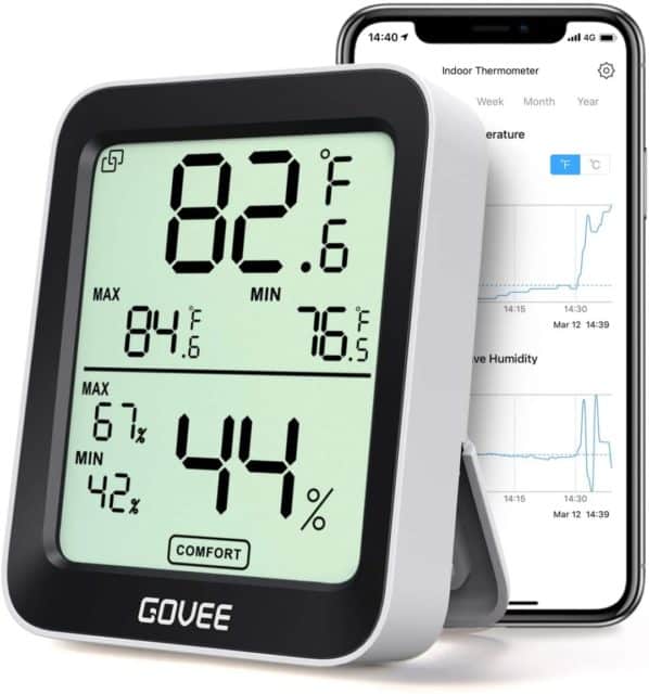 A thermometer-hygrometer tells the temperature and humidity level inside a greenhouse.