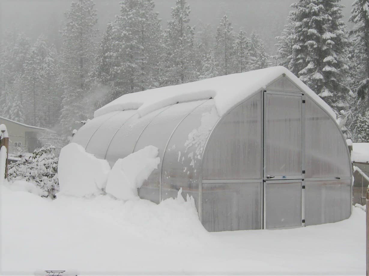 a greenhouse covered in snow needs a greenhouse heater and other accessories