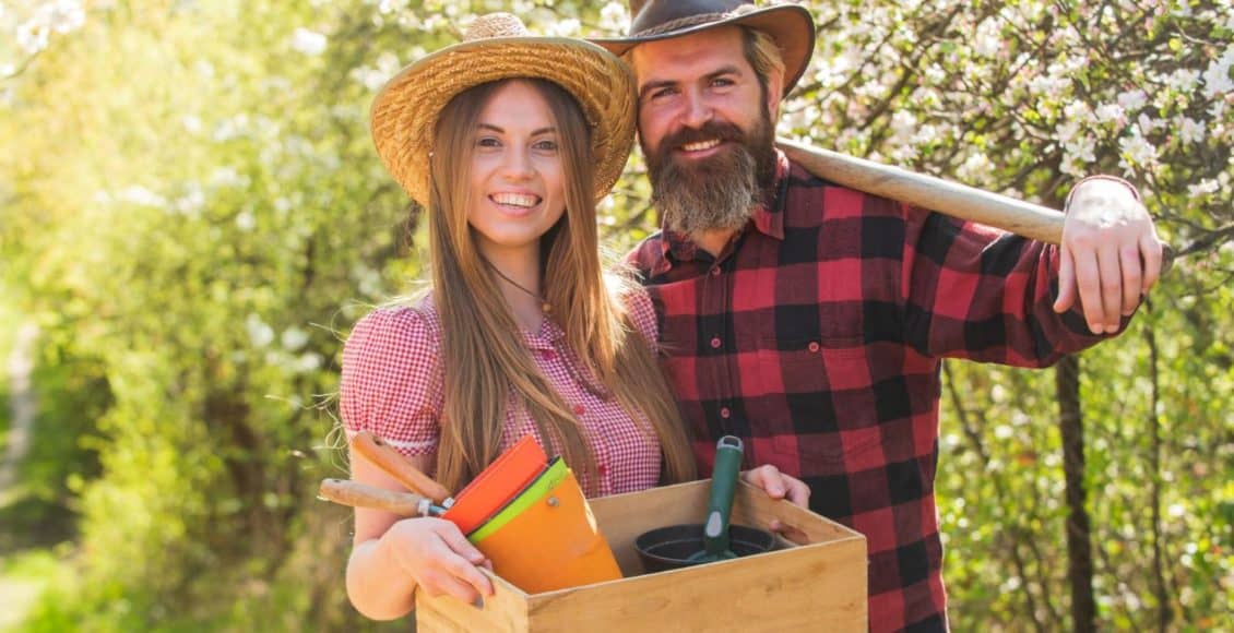 A young man and woman take a break on their family hobby farm.