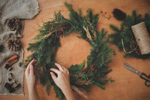 Rustic holiday decor includes a homemade evergreen wreath