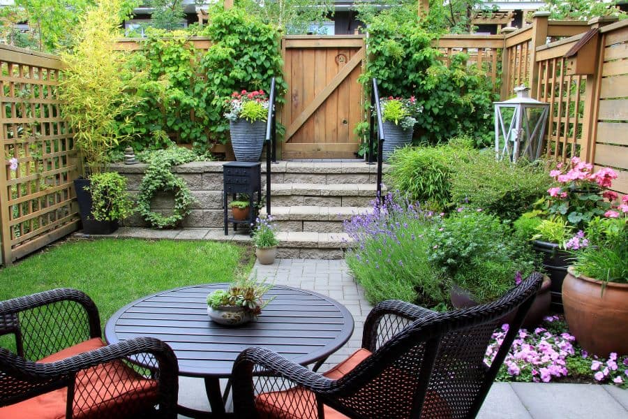 a small backyard garden with a sitting area