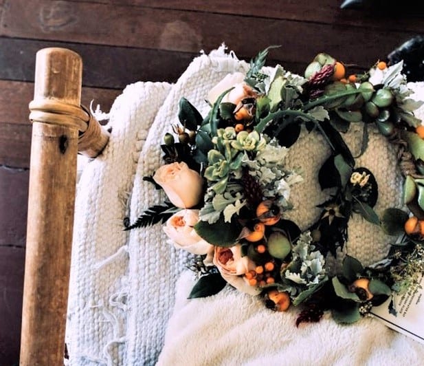 dried flower wreath on a bed