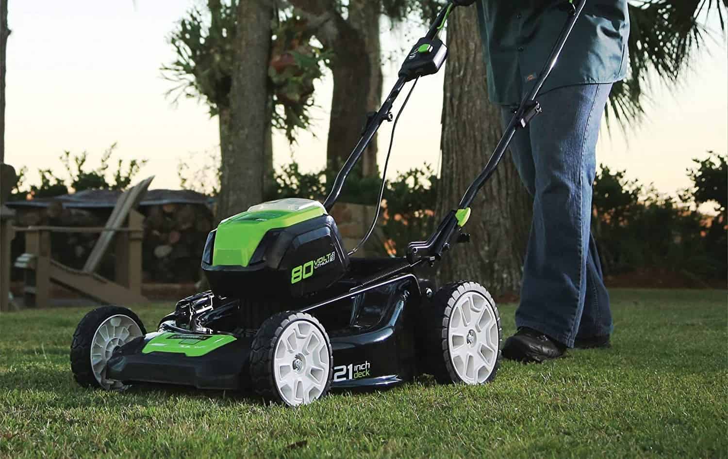 man mows lawn with mower