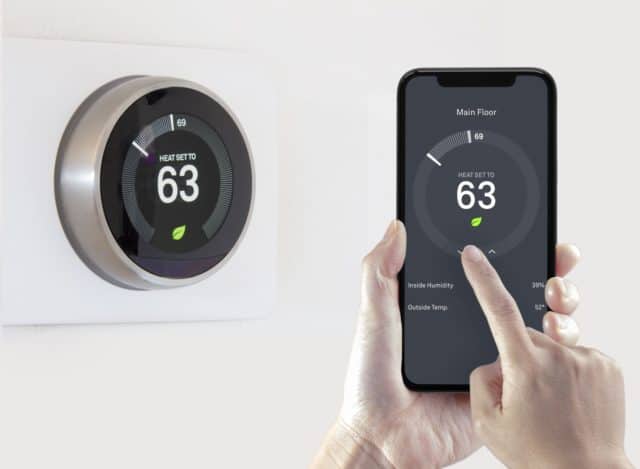 A Google Nest smart thermostat can be controlled using a smart phone