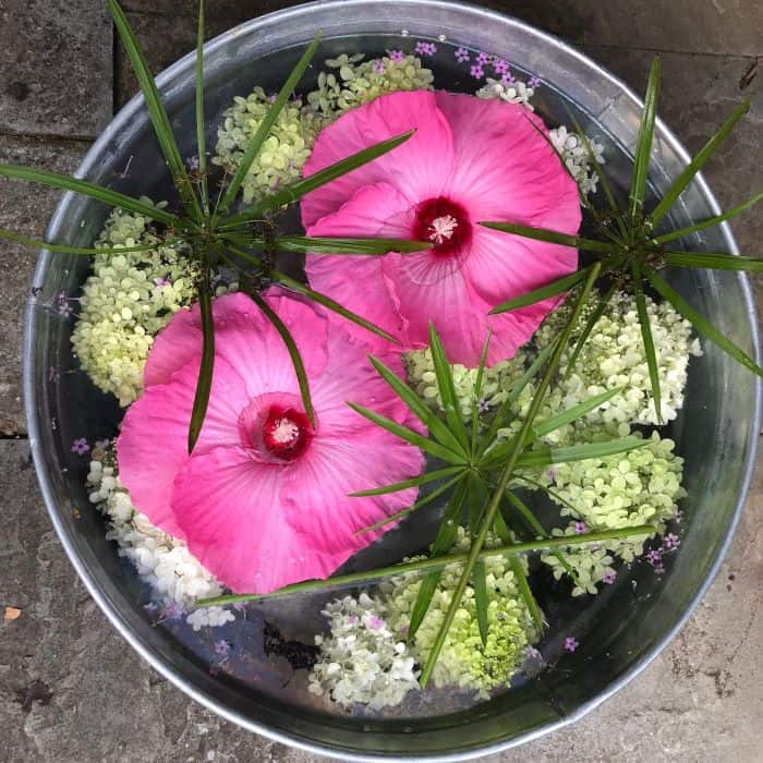 flowers and foliage floating in a bowl of water