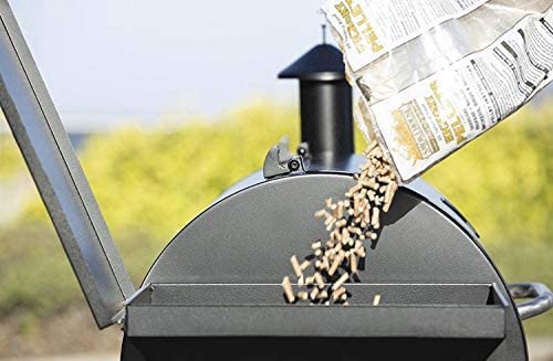 wood pellets are poured into the hopper of a pellet grill