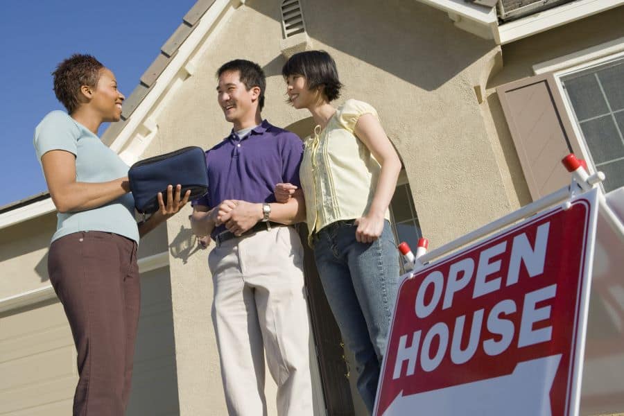 a realtor talks with a couple at an open house