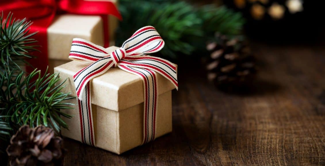 a wrapped gift under a Christmas tree