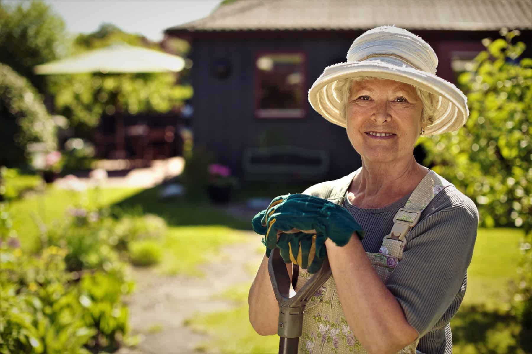 senior woman standing in a garden