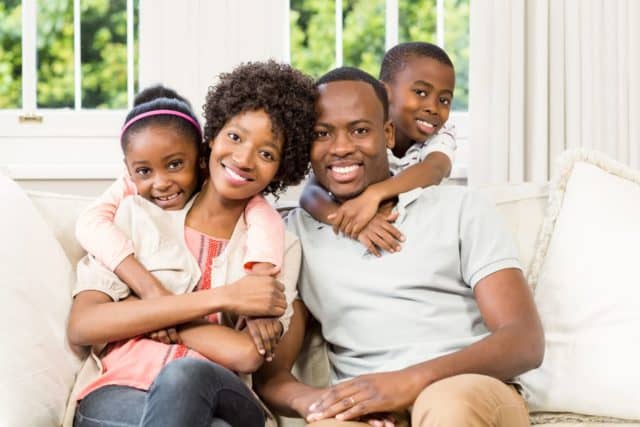 happy black family at home on the couch