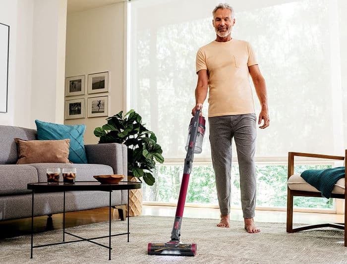 man cleans floor with Shark IZ163 best cordless vacuum cleaners