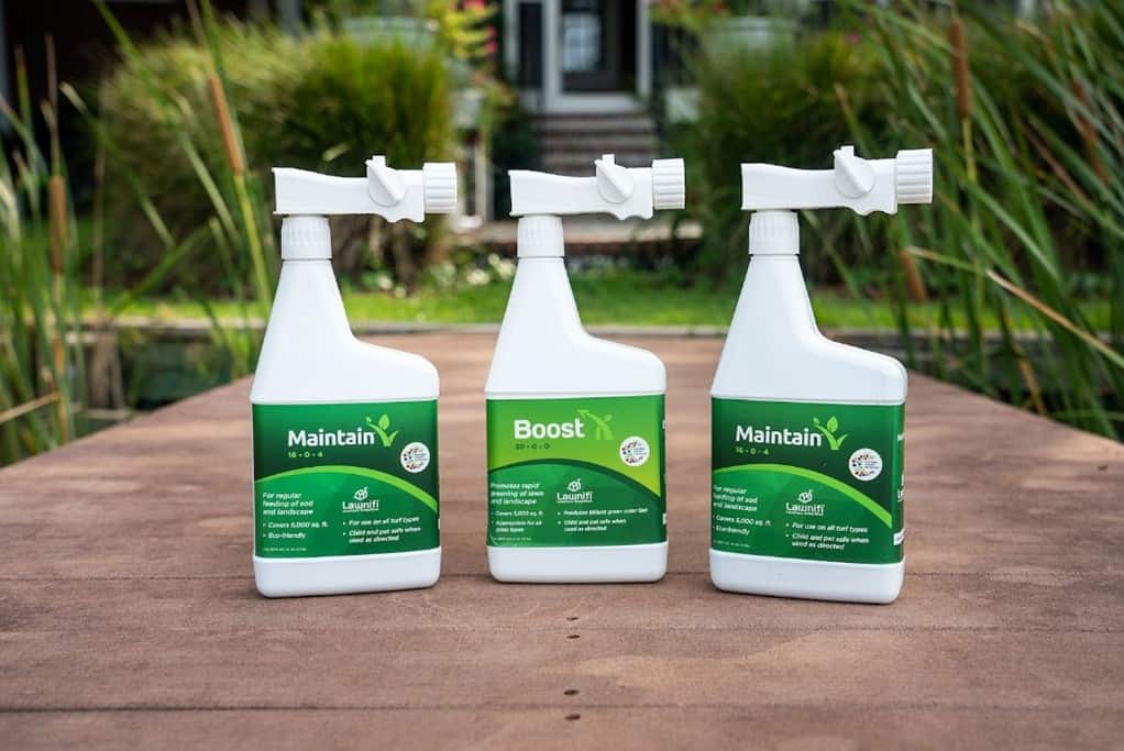 spray bottles of liquid lawn fertilizer for spring lawn care