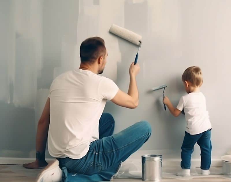 father and son painting a wall